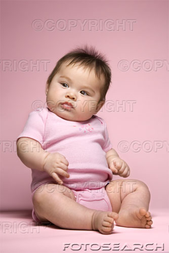 fat baby - Asian baby sitting up and looking to side.