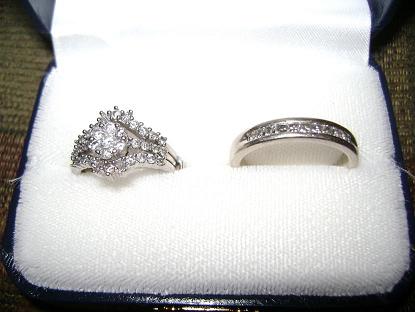 Engagement Rings - This of a picture of my hubby and I rings. They are white gold. Mine has an engagment ring on the inside and is surrounded on both sides with a band. It is real diamonds and we are still paying on them. We've been married for a little over a year.