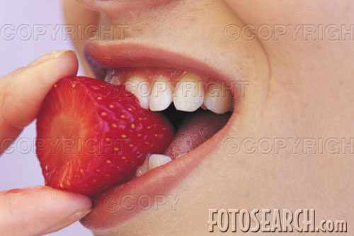 strawberry - woman putting strawberry in mouth.