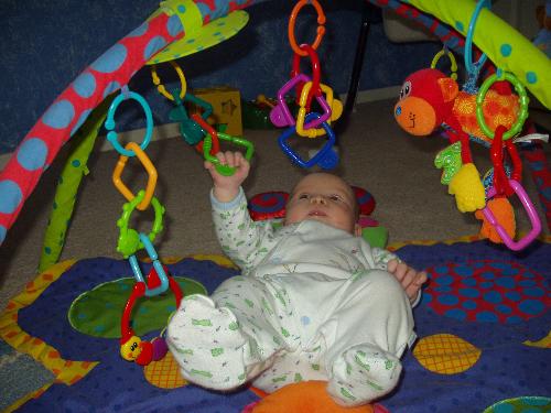 look at him grab!! - at 2 months old he's starting to grab at his toys :)
