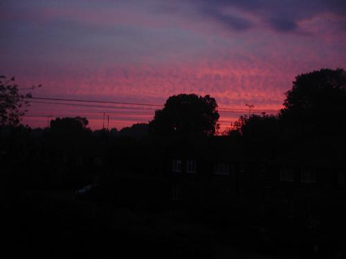 Sunset - The sun sinks amongst pink and purple streaks in the sky. Sunset - The sun sinks amongst pink and purple streaks in the sky.