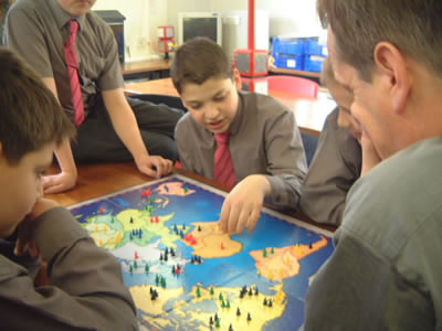 Board Games. Kids playing Risk - When was the last time you sat down and played a board game?