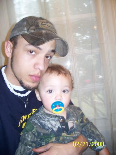my oldest son and his son - Here my son is holding his son. They are a great 2 together. He is single and looking.