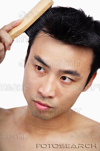 hair - man brushing his hair.