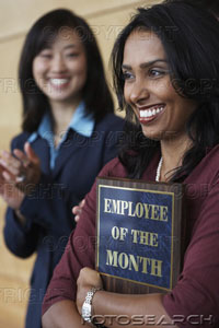 employee - businesswoman holding employee of the month plaque.