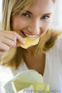 potato chips - woman eating potato chips