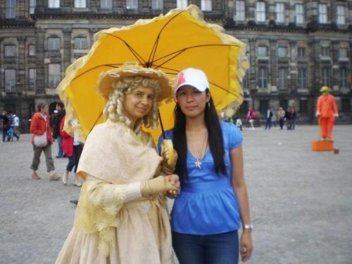 Picture w/ cinderella 'The Dam' - She is wearing a custom for the tourists.You can make a picture of her aor be near her but then you have to give some tips before you take picture..They do that to earn money..
