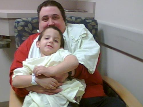 Son on day of Surgery - Son had to have tonsils and adnoids out, this was just after he got his happy juice..and he wanted to be by his Daddy.