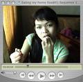 An Asian woman eating -   She's enjoying the stuff very much.