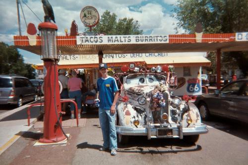 Me at Kingman, Arizona - When me and my family went to the Grand Canyon, we found this town. it is a small town, which is actually seen on a Penzoil commercial. It is a tiny town off of Route 66 in the middle of the desert in Arizona. We stopped at a locally famous ice cream shop, where they had all kind of stuff, including some antique cars, which I posed by.