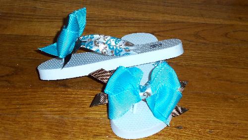 Custom Made Boutique Flip Flops - One of my recent creations.

White Old Navy Flip Flops with Blue, Brown & White Designed Ribbon Straps & Blue Bow.
