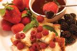 Chocolate fondue - assortment of fruit and cake for dipping