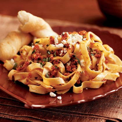 Pasta with Sun-Dried Tomato Pesto and Feta Cheese - Pesto sauce is always a good partner for piping hot pasta, and this one contributes an extra hit of flavor from the sun-dried tomatoes and almonds.