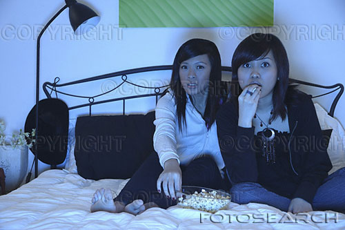 watching tv - two woman watching tv