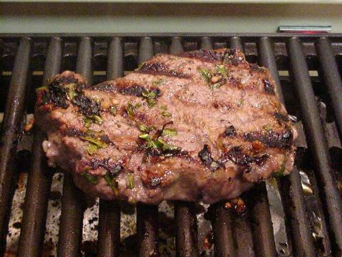 grilled marinated steak - grilled medium rare steak garnished with oregano