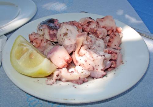 Octopus sald - octopus salad with a wedge of lemon