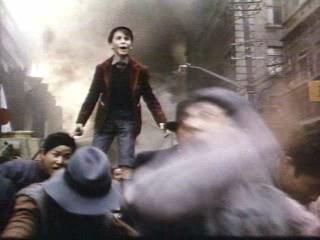 Christian Bale - Christian Bale from Empire of the Sun standing atop a car looking in the crowd and shouting for his parents in film opener