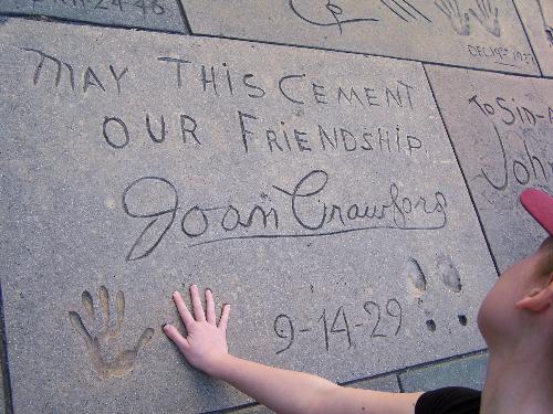 Me playing with Joan Crawford's handprints in Holl - Joan Crawford's square at the Graumann's Chinese Theater on Hollywood Boulevard