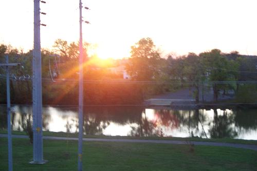 The sun sets - The sun is setting behind the river in my town.