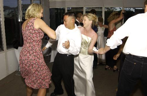 Me dancing it up - This was taken at my aunt's wedding back in June 2004. Two girls and me. Werd.