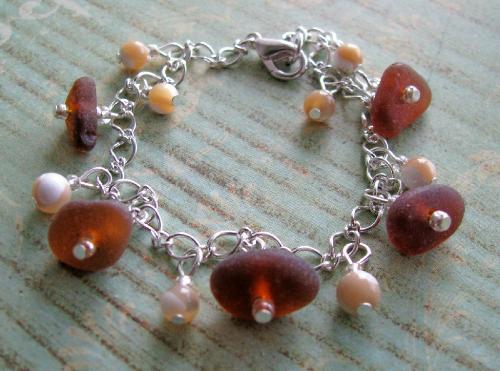 Brown Sea Glass Bracelet - Available at my Etsy.com shop. This piece bracelet has 5 dark brown pieces of sea glass accented with polished shell beads. This piece is great for summer and will transition well into a great fall accessory!