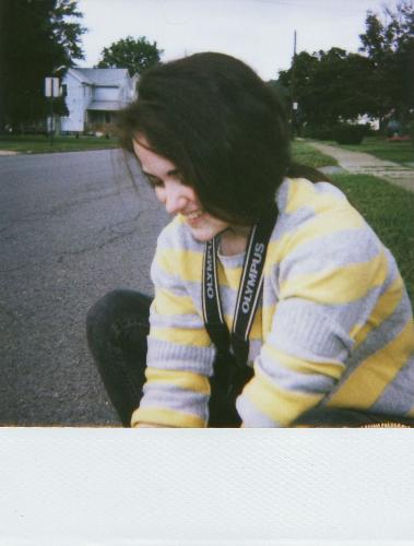 Me - I found this curb after walking all day in my holey moccasins; I sat to tie their strings and as I did so my friend Beth decided to grab my old 1989 polaroid camera and take a picture. Sadly now that polaroid declared that they are discontinuing the production of film there will be no more spontaneous pictures like this again. I will surely cling on to my last pack of film.