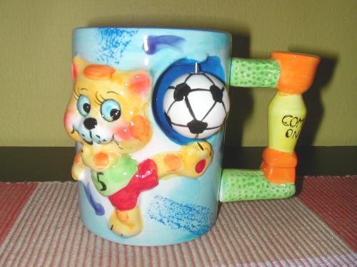 My Football Cup - My little niece presented me with a cup for my hot drinks. Knowing that I'm a Football fan, she saw this at a shop, and got it for me. It's a ceramic cup, with a little tiger kicking a football. Colourful and cute!