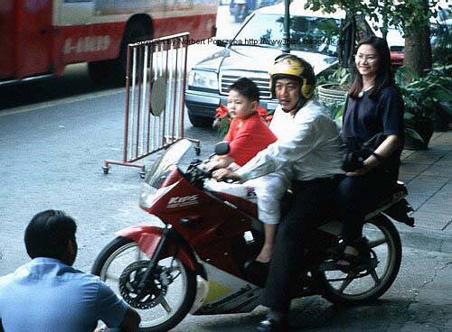 the way to go - a family riding motorcycle, saving gas