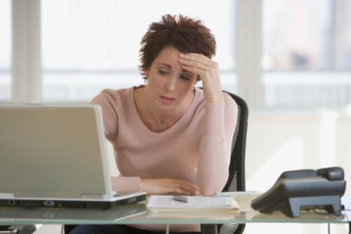 woman stressed out - photo of business woman stressed out at laptop