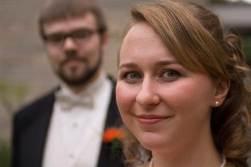 wife - bride and groom with bride in front in front of church