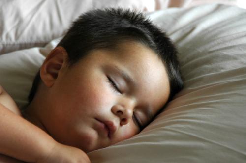 Sleeping - A cute baby sleeping, not aware of the things happening around him.