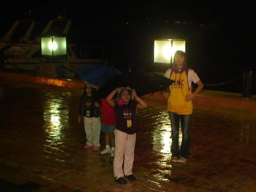 play in the rain - it's my nieces who are playing in the rain. kids really love rains. maybe because it's cold and you have your umbrella to hold on to. specially if you are near the sea.