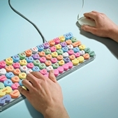 internet keyboard - man typing on computer keyboard candy hearts