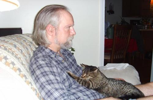 Hubby and his cat - This is my husband holding HIS cat. MY cat is the nice one! His hates everyone but him! She's deranged. LOL