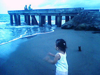 child - a happy child playing in the beach