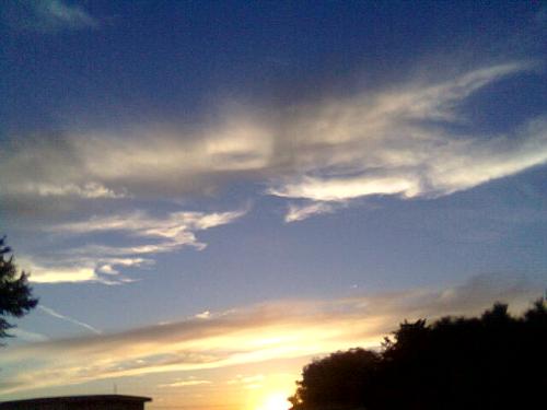 Sunsets in the Midwest -  A few wisps of clouds linger in the evening sky. Darkness is fast approaching as we sit motionless against yesterdays shadows. We gaze into each others eyes, content in the fact that we are together at last. You are beautiful! I love all that you are!