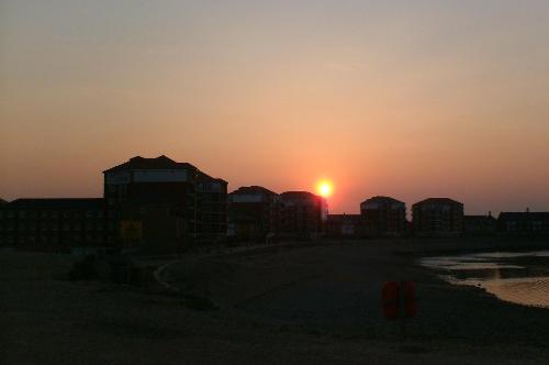 The sun setting behind the houses - The sun setting behind the houses