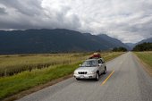 couple driving vehicle - photo of couple driving utilty vehicle on rural road