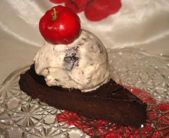 Homemade Cookies &#039;n Cream Ice Cream - Homemade Cookies &#039;n Cream Ice Cream on my homemade flourless chocolate cake!