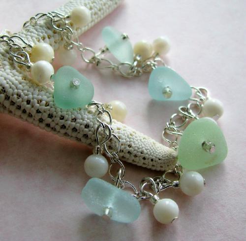 Pale Aqua Blue and Seafoam Sea Glass Bracelet - This 7 1/2' silver plated bracelet is adroned with five pieces of authentic sea glass in pale aqua blue and pale seafoam green. These beautifully smoothed pieces of sea glass are accompanied by polished shell beads in ivory swirled white. This bracelet is a wonderful summer accessory ~ very feminine and delicate!  Aqua blue sea glass is graded as in the category of RARE.