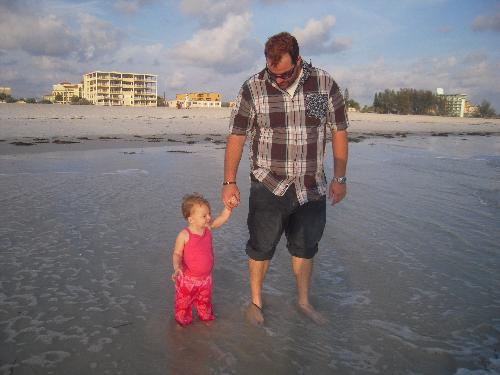 beach, parenting - Baby and daddy a the beach watching the sunset and playing in the waves