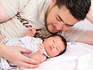 Pregnant Man and His Baby - The man who had got pregnant is seen here photographed with his newborn baby girl.