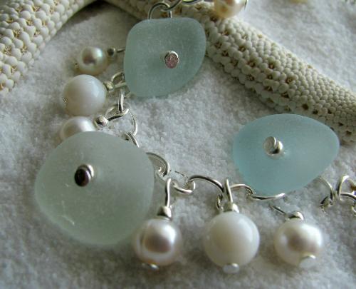 Summer Dreams Sea Glass Bracelet - 3 frosty white /clear and 2 pale blue pieces of genuine sea glass adorn this 7 1/2' silver plated bracelet. Fresh water pearls and white polished shell beads accent the gorgeous sea glass in this dreamy and delicate bracelet.