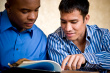 reading - photo of two men reading a book