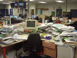 messy desk - not my desk but a very messy desk
