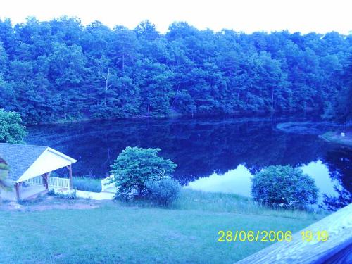 Our Lake at Dusk - I took this picture just as the sun went down. It is a view of our lake from our deck off the back of our house. Just to the right of the pavilion is another deck that sits out over the water and next to that is our pier.  We love to sit on the deck in the evening and just gaze out over the lake. It's so peaceful!