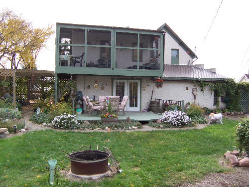 Our summer 'outdoor living room' - This photo was taken of our backyard space in the early fall. We use it as our outdoor living room all summer long. Lower deck and upper deck...that is our bug-free zone!