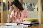 stressed - photo of a young woman studies in the library