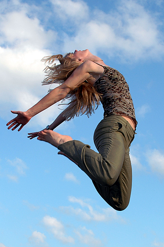 jumping in the air - a woman jumping in the air, saying it loud to the world, i have lived my life to the fullest. excited. happy. fun. joyful