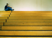 bleachers - photo of boy sitting on top bleachers